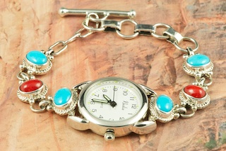 Genuine Sleeping Beauty Turquoise and Coral set in Sterling Silver. The Sleeping Beauty Turquoise mine is located in Gila County, Arizona. Ladies Watch Bracelet Created by Navajo Artist Geneva Chavez.